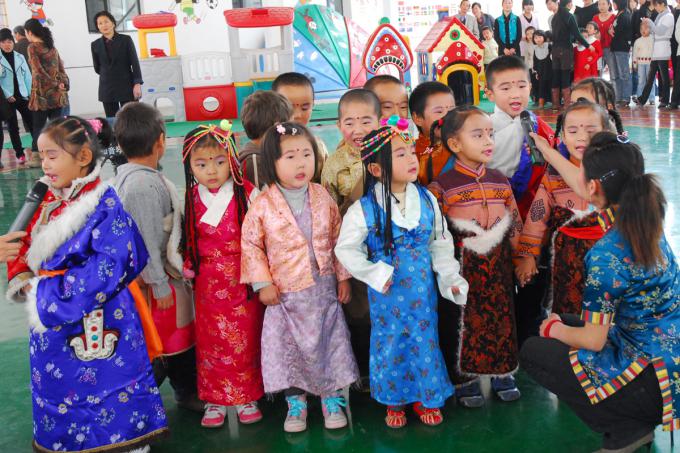 Standing anxiously before a gathering of family and friends, the students at this new Tibetan-language kindergarten in Xining perform folk songs in traditional dress.